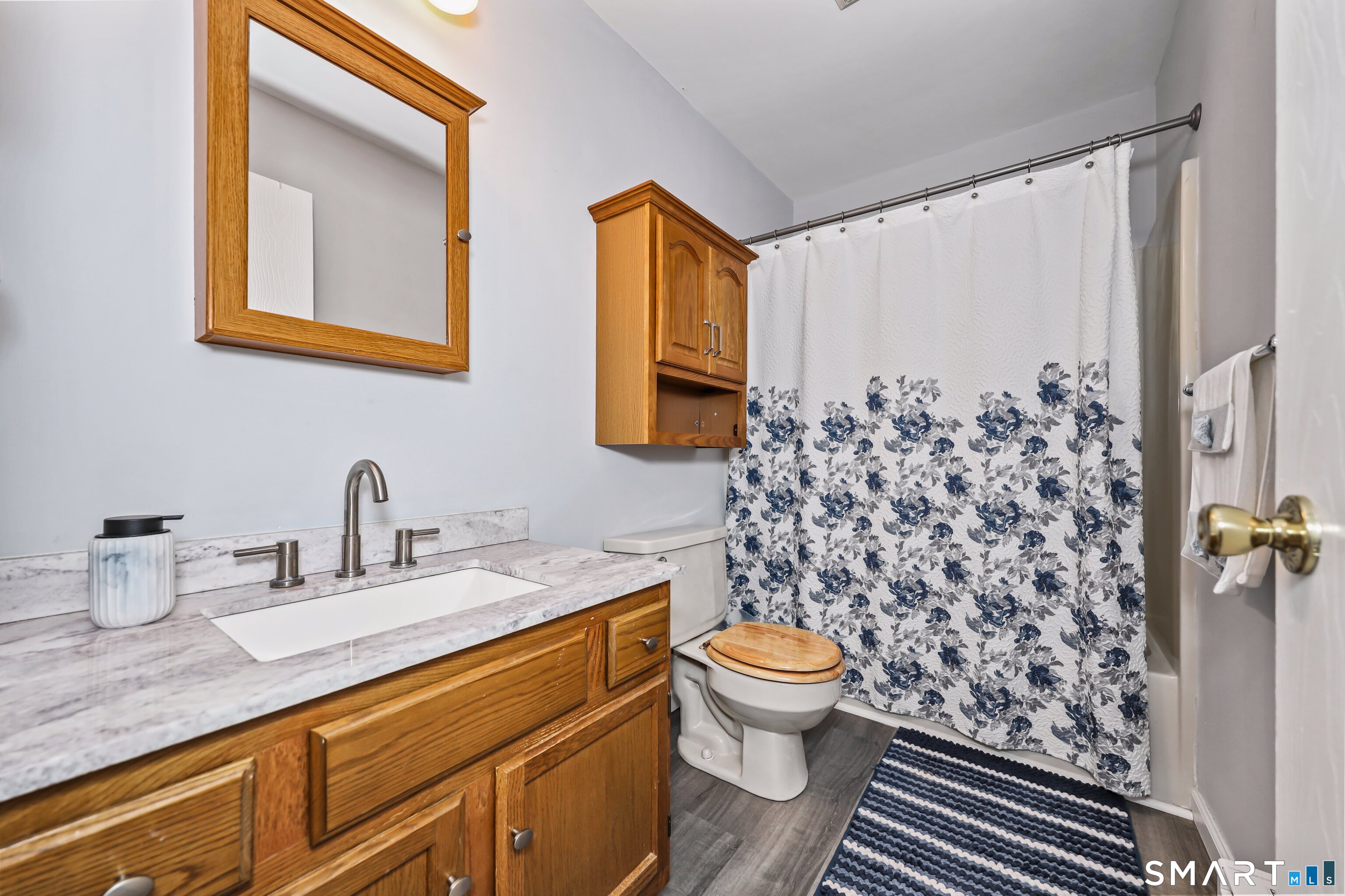 143 Pine Hill Road, Unit 5C Thomaston, CT 06787 - Photo 16 of 29 a bathroom with a granite countertop toilet sink and mirror