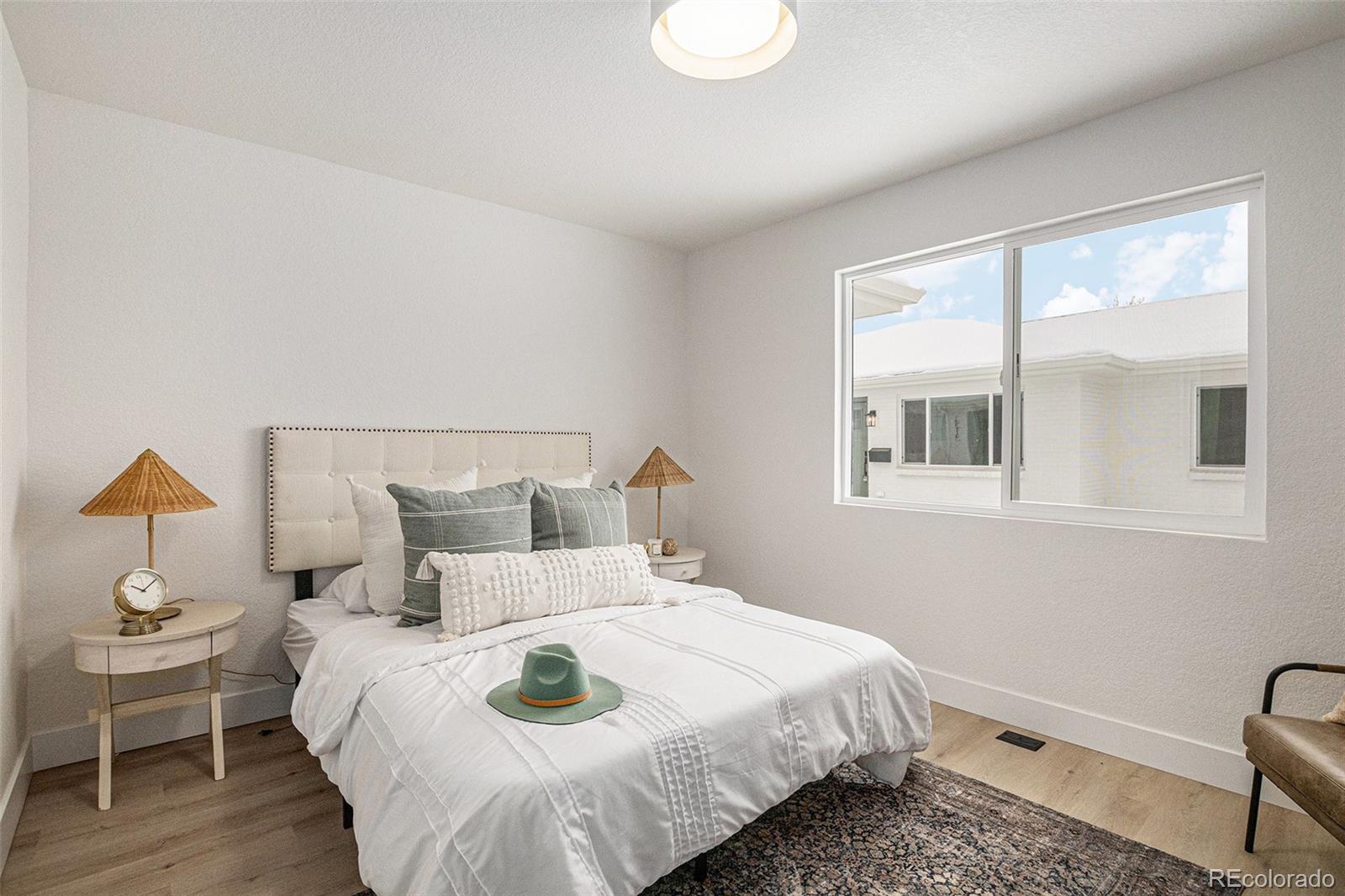 3211 Steele Street Denver, CO 80205 - Photo 14 of 26 a bedroom with a bed and a window