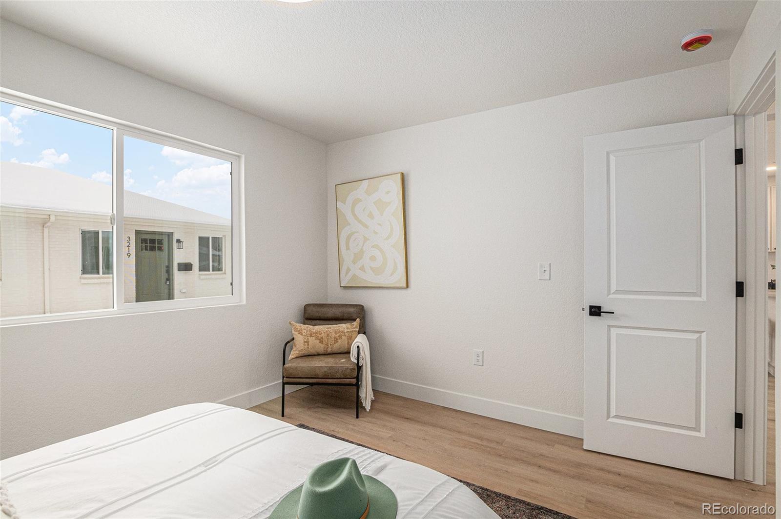 3211 Steele Street Denver, CO 80205 - Photo 17 of 26 a bedroom with a bed and a window