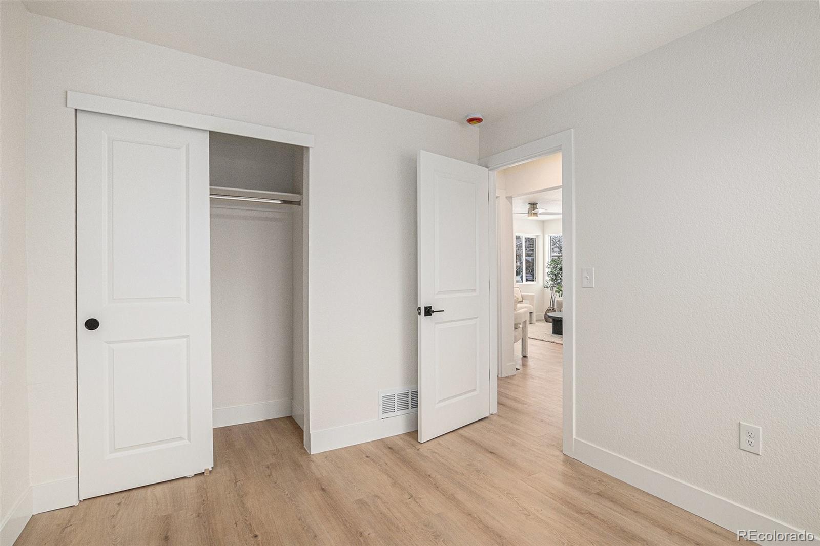 3211 Steele Street Denver, CO 80205 - Photo 18 of 26 a view of an empty room and wooden floor