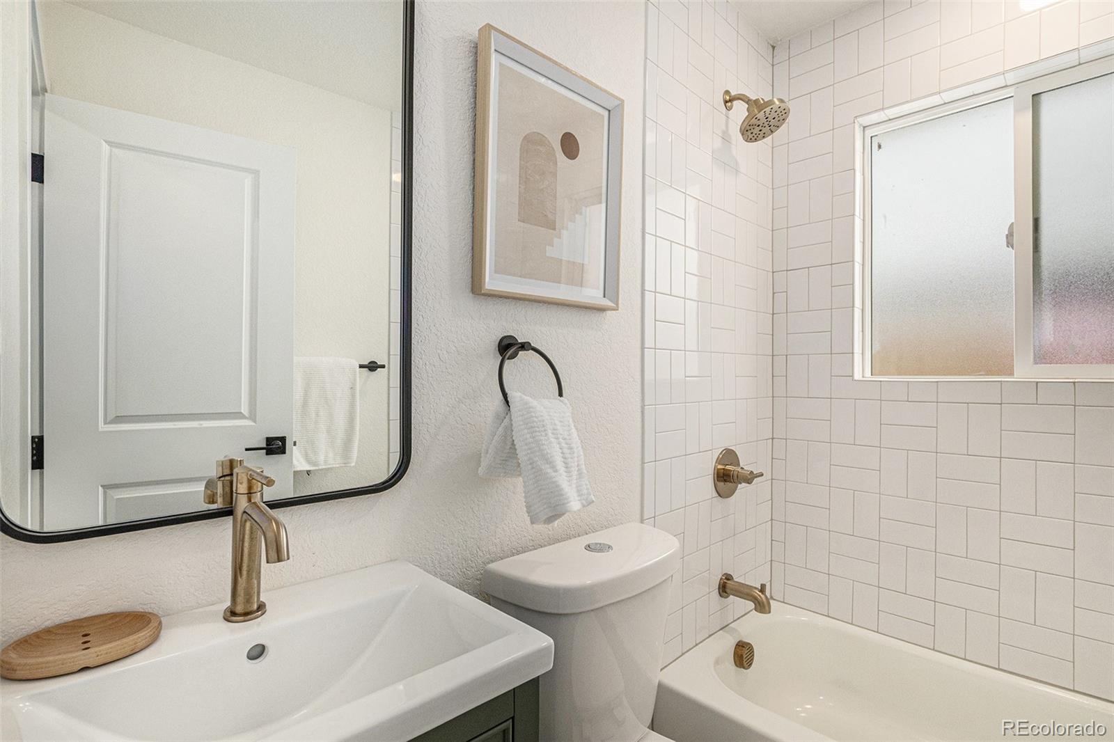 3211 Steele Street Denver, CO 80205 - Photo 20 of 26 a bathroom with a sink toilet and shower