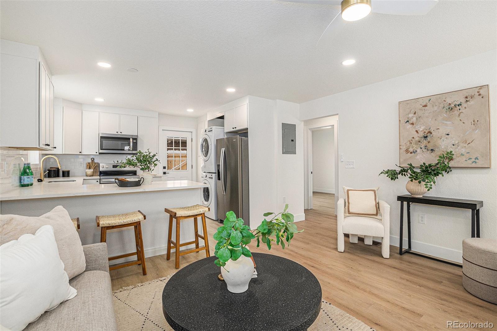 3211 Steele Street Denver, CO 80205 - Photo 2 of 26 a kitchen with sink and refrigerator