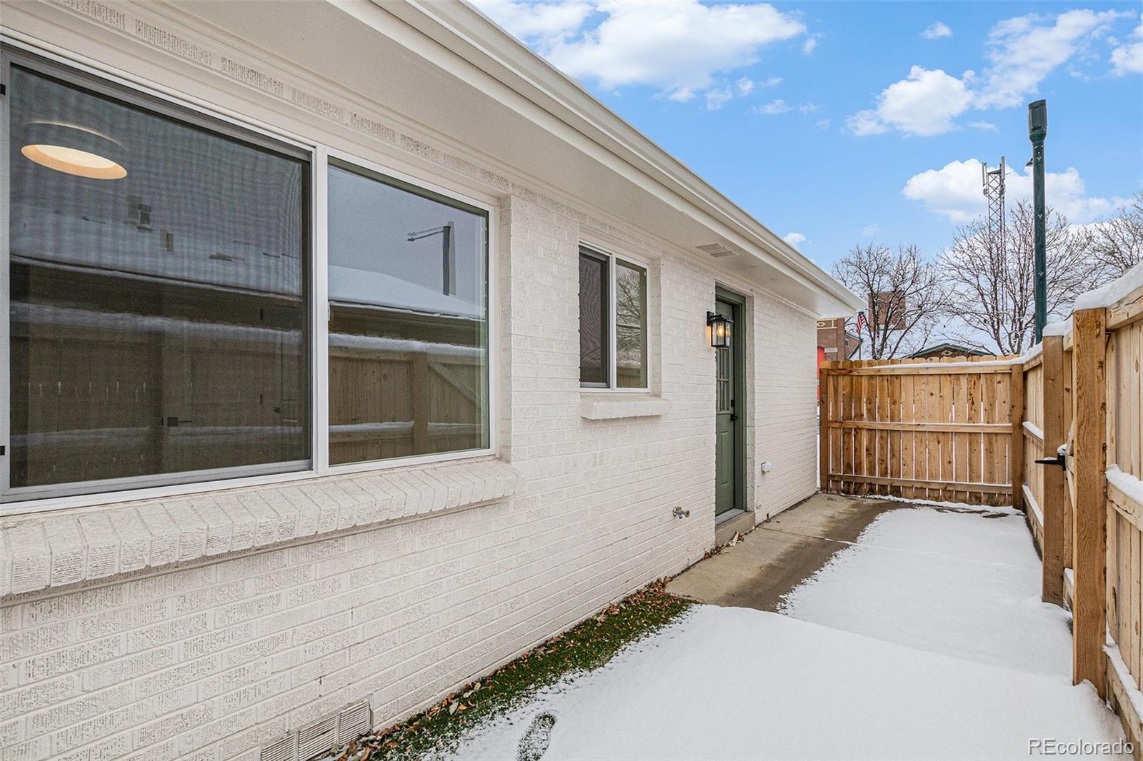 3211 Steele Street Denver, CO 80205 - Photo 22 of 26 a view of a house with a wooden fence