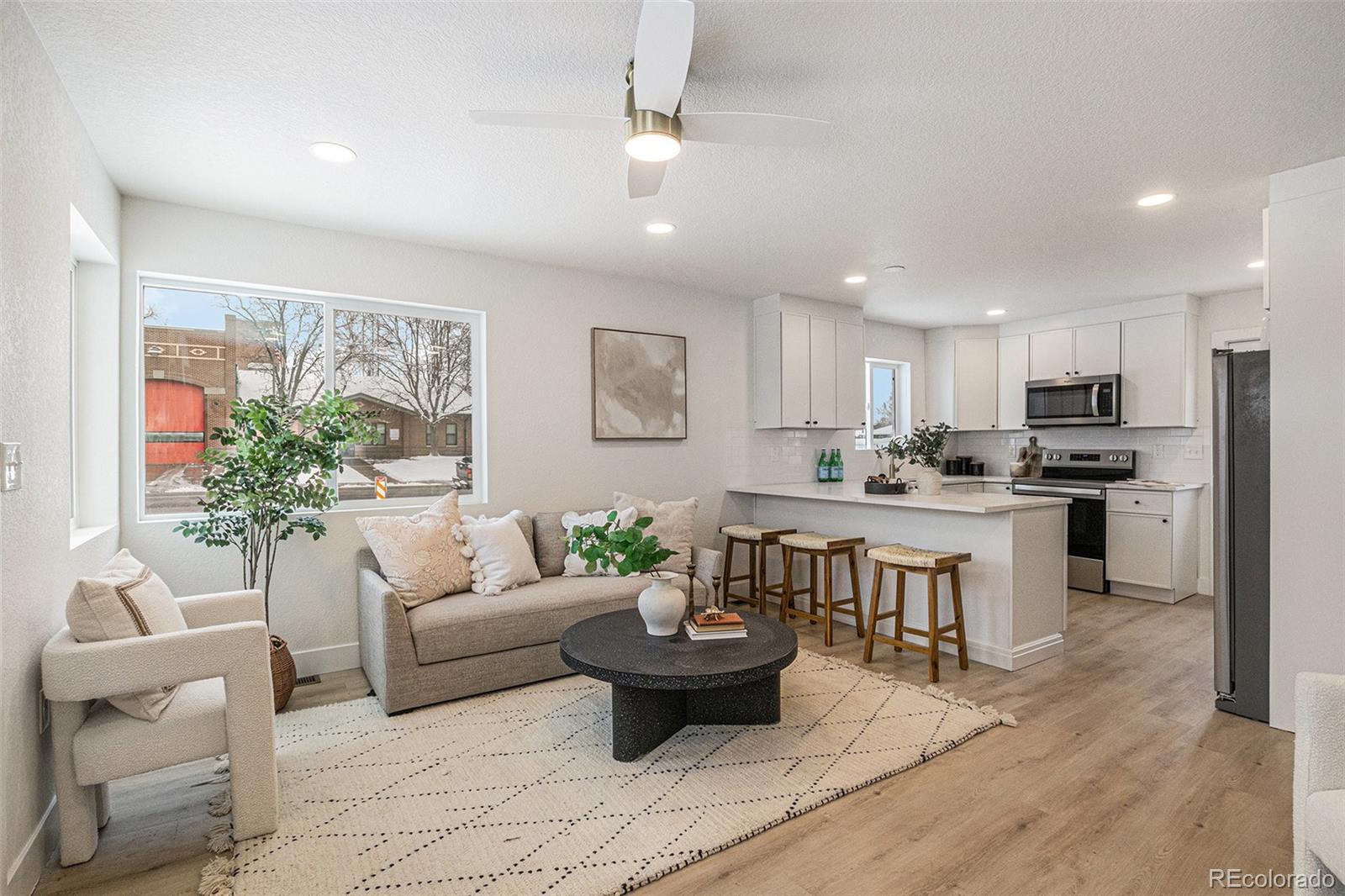 3211 Steele Street Denver, CO 80205 - Photo 23 of 26 a living room with furniture kitchen and a table