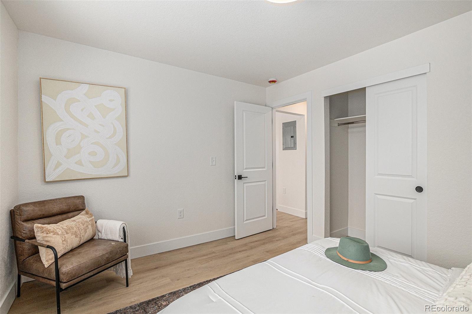 3211 Steele Street Denver, CO 80205 - Photo 24 of 26 a bedroom with a bed and a chair