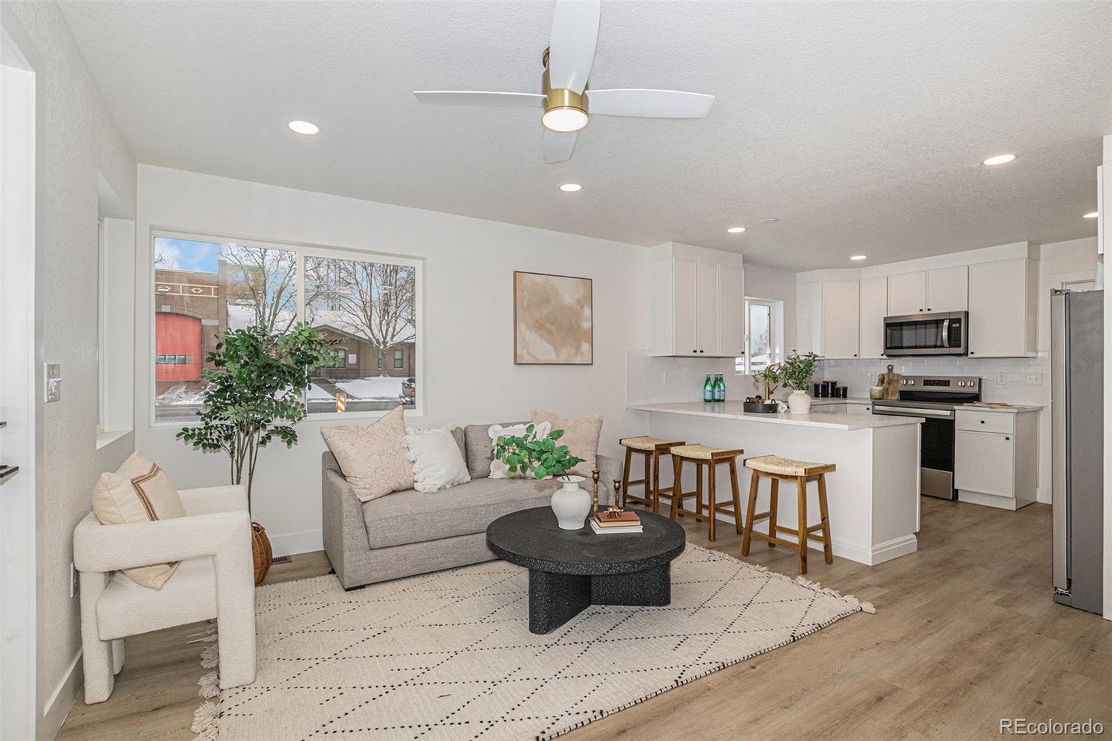3211 Steele Street Denver, CO 80205 - Photo 3 of 26 a living room with furniture potted plant and kitchen view