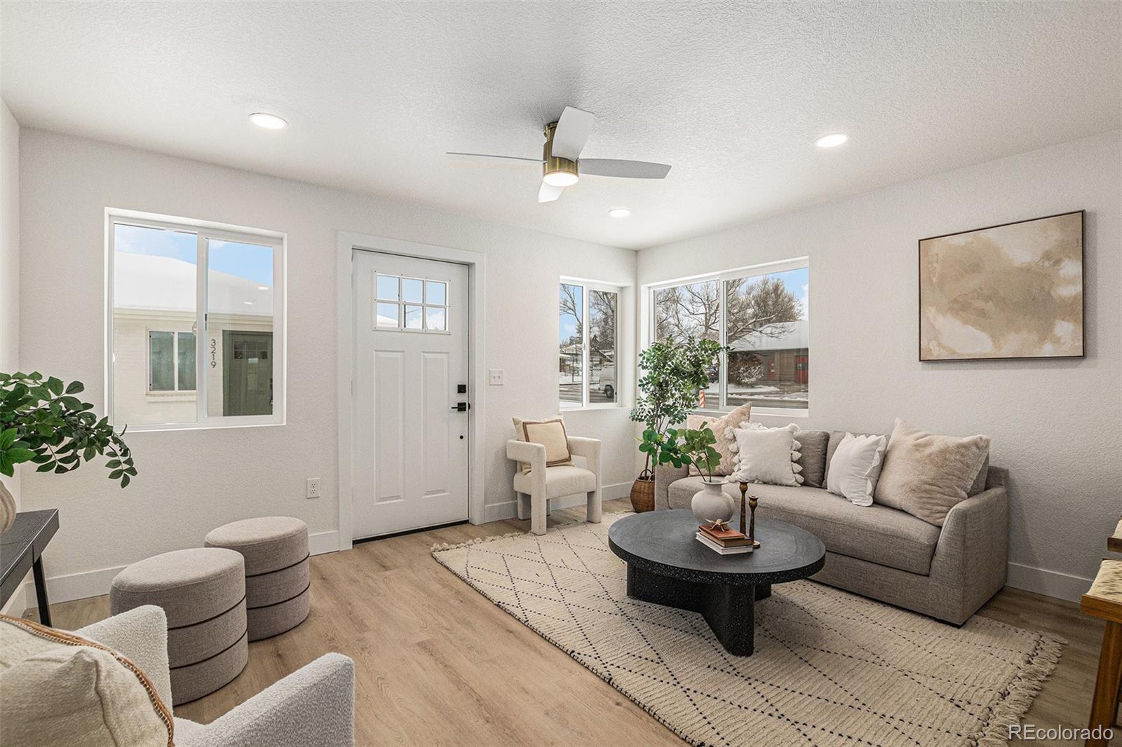 3211 Steele Street Denver, CO 80205 - Photo 4 of 26 a living room with furniture and a large window