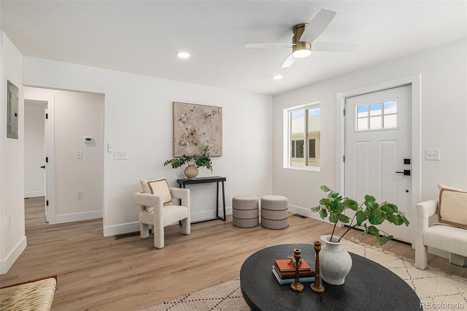 3211 Steele Street Denver, CO 80205 - Photo 8 of 26 a living room with furniture and a wooden floor