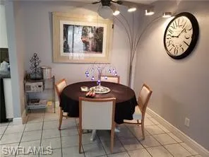 a view of a hallway with chairs and a stove in it