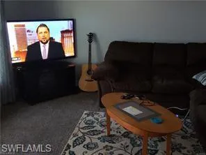 a living room with furniture and a rug