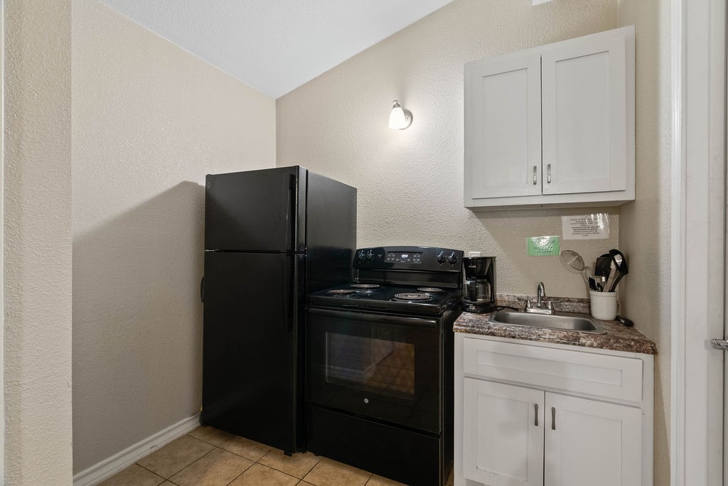 919 North Fulton Beach Road, Unit 324 Fulton, TX 78382 - Photo 12 of 21 a kitchen with a refrigerator and cabinets
