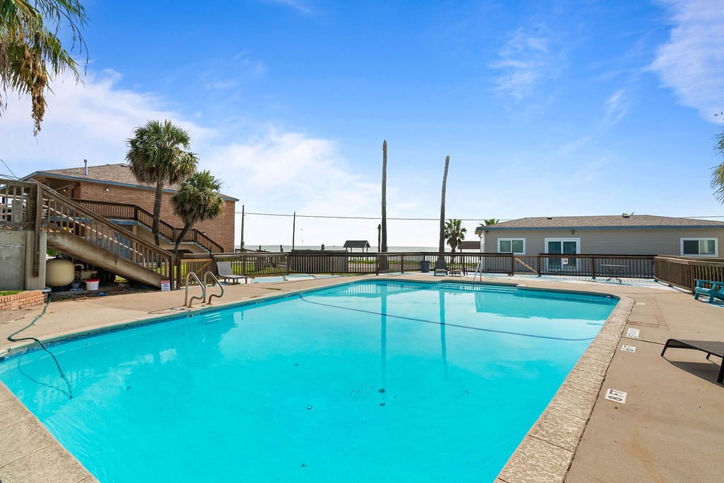 919 North Fulton Beach Road, Unit 324 Fulton, TX 78382 - Photo 19 of 21 a view of a swimming pool with a chair and tables