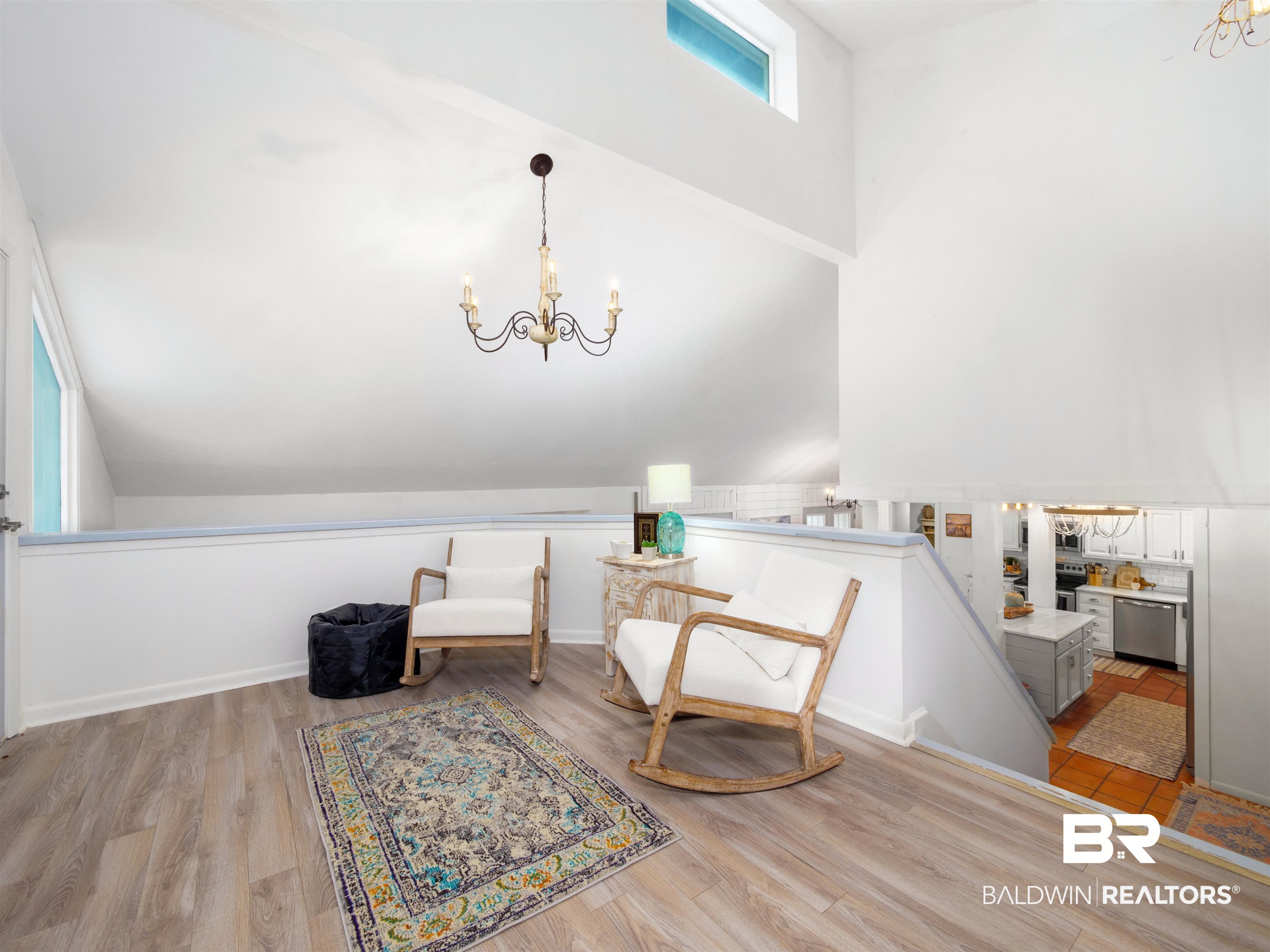 494 Ridgewood Drive Daphne, AL 36526 - Photo 22 of 40 Living area featuring vaulted ceiling, light hardwood / wood-style flooring, and an inviting chandelier