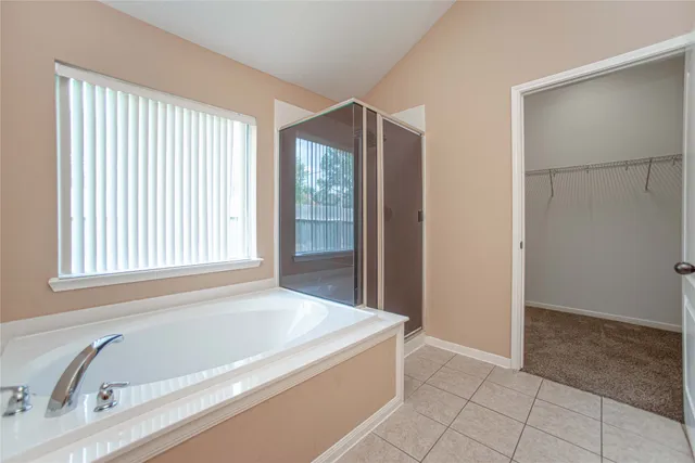 a bathroom with a bathtub and a shower