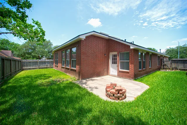 a backyard of a house with garden and deck