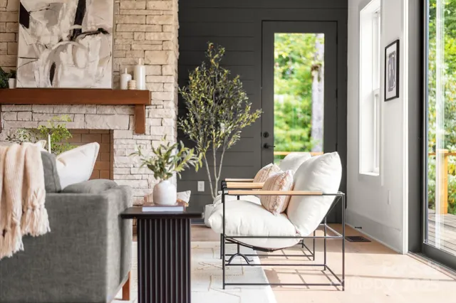 a living room with furniture and a floor to ceiling window