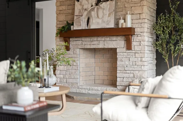 a living room with furniture a rug floor to ceiling window and wooden floor