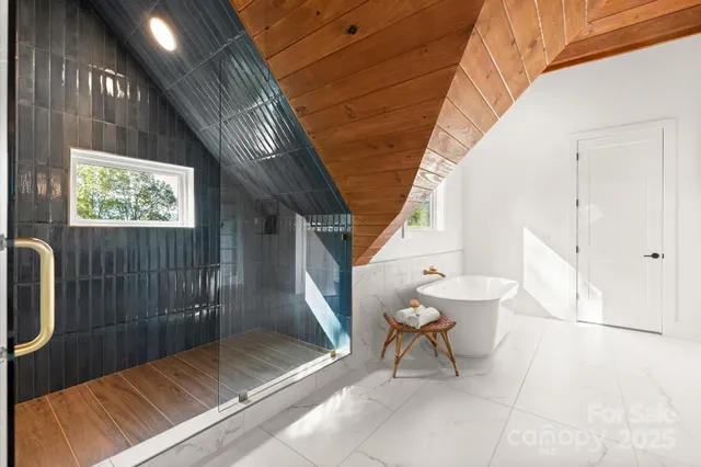 a large bathroom with a double vanity sink a large mirror and a bathtub