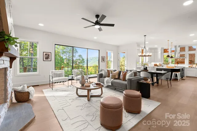 a living room with furniture a table and a large window