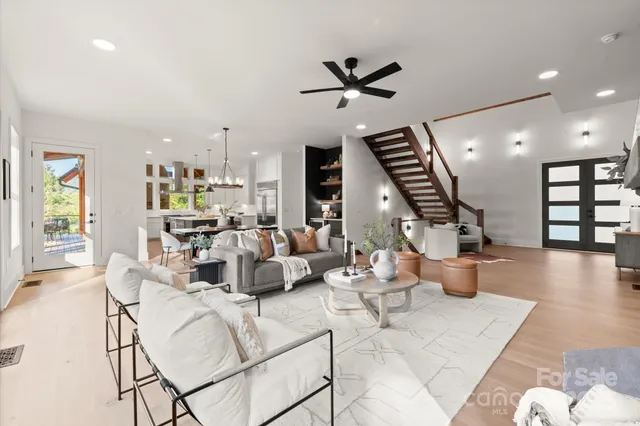 a living room with furniture and wooden floor