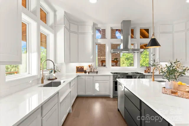 a very nice looking kitchen with a large window appliances and cabinets