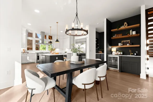 a view of a dining room with furniture kitchen and chandelier