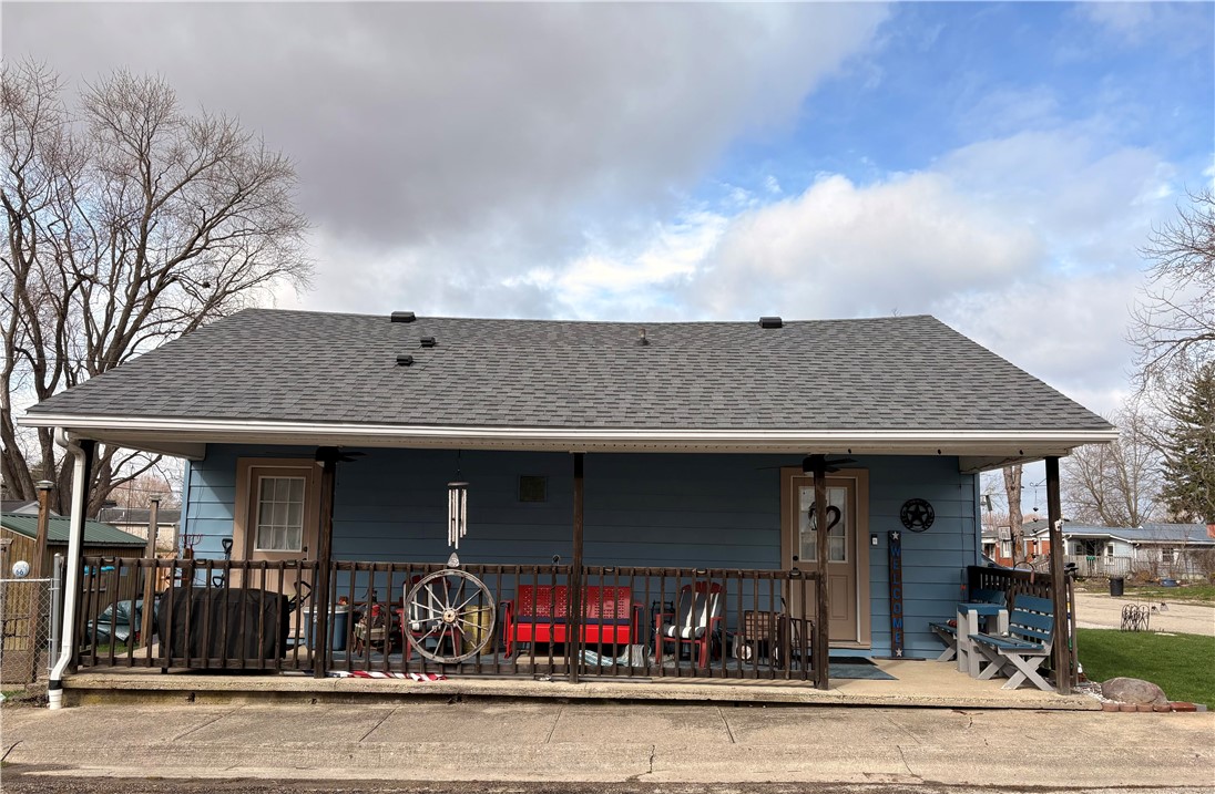 This charming home offers a welcoming front porch, perfect for enjoying peaceful moments outdoors.