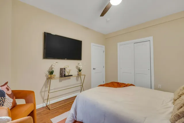 a bedroom with a bed and a flat screen tv