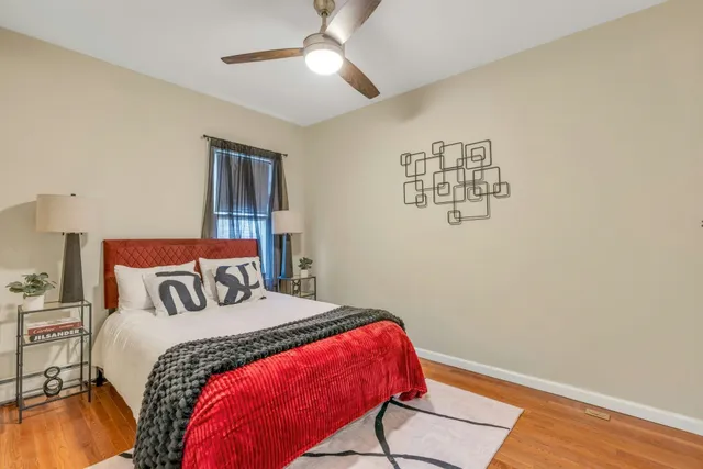 a bedroom with a bed and a chandelier