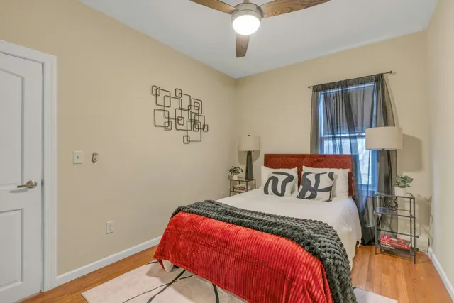 a bedroom with a bed and a chandelier