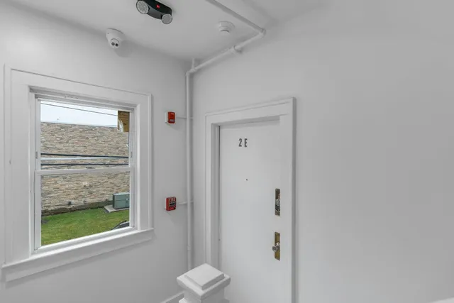 a bathroom with a window and a shower