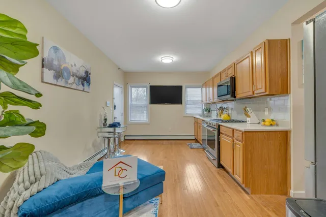 a kitchen with stainless steel appliances granite countertop a refrigerator and microwave