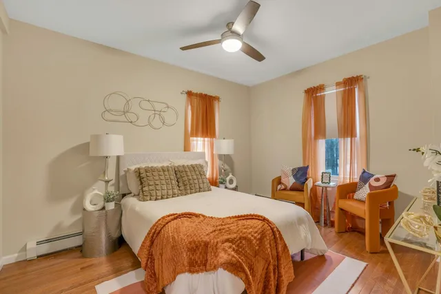 a bedroom with a bed and wooden floor