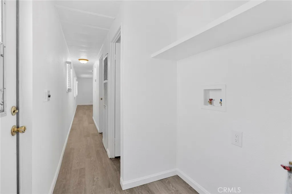 15252 Seneca Road, Unit 161 Victorville, CA 92392 - Photo 13 of 18 a view of a hallway with wooden floor
