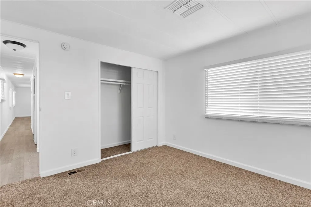 15252 Seneca Road, Unit 161 Victorville, CA 92392 - Photo 15 of 18 an empty room with windows