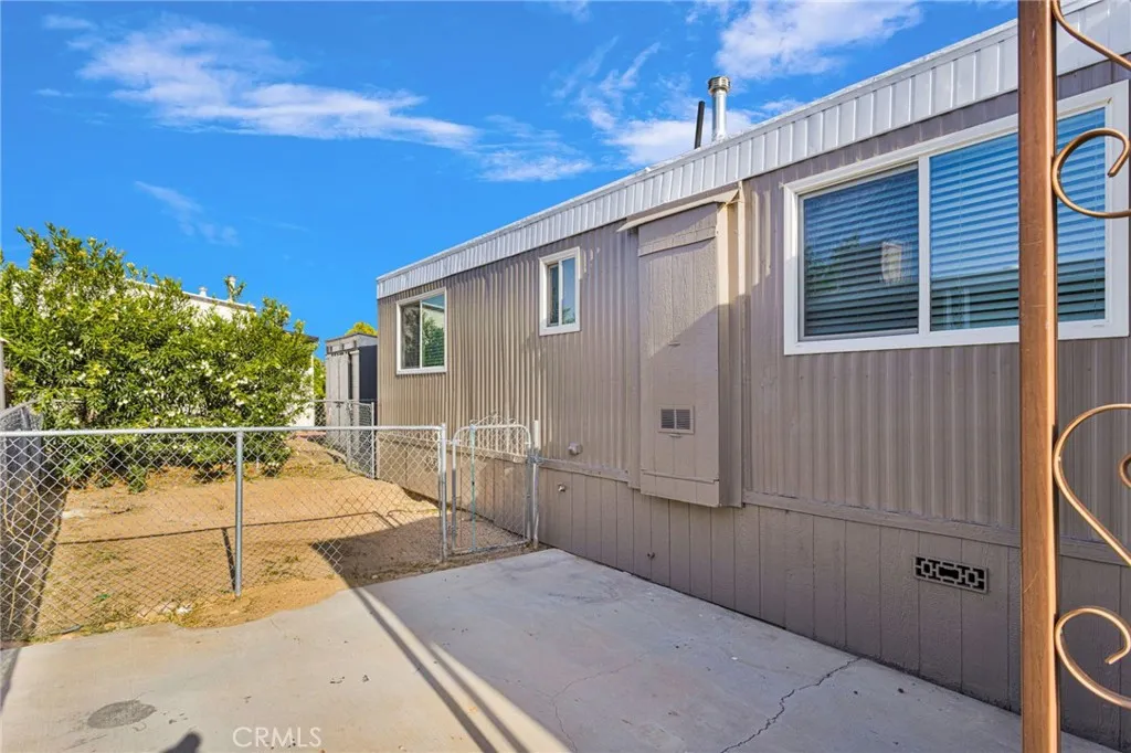 15252 Seneca Road, Unit 161 Victorville, CA 92392 - Photo 16 of 18 a backyard of a house with wooden floor