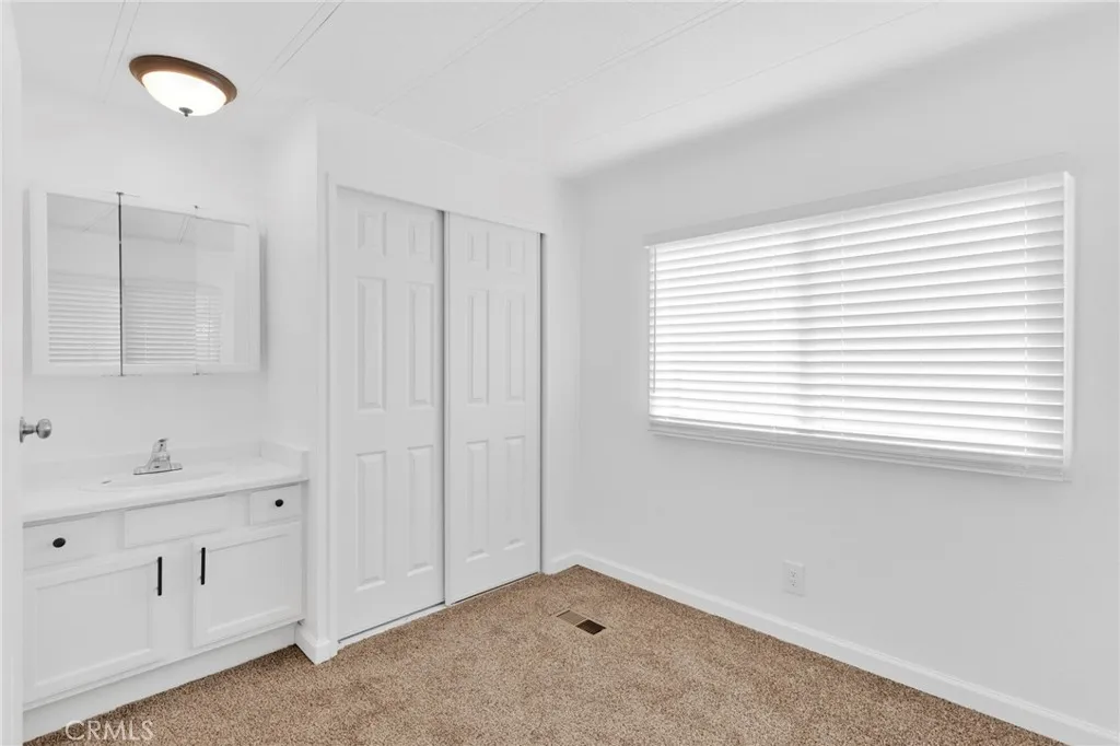 15252 Seneca Road, Unit 161 Victorville, CA 92392 - Photo 7 of 18 a bathroom with a sink and a window