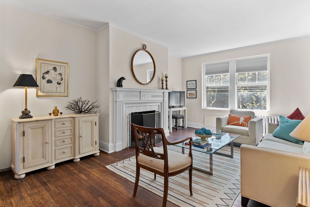 321 Tappan Street, Unit 1 Brookline, MA 02445 - Photo 3 of 31 a living room with furniture a fireplace and a table