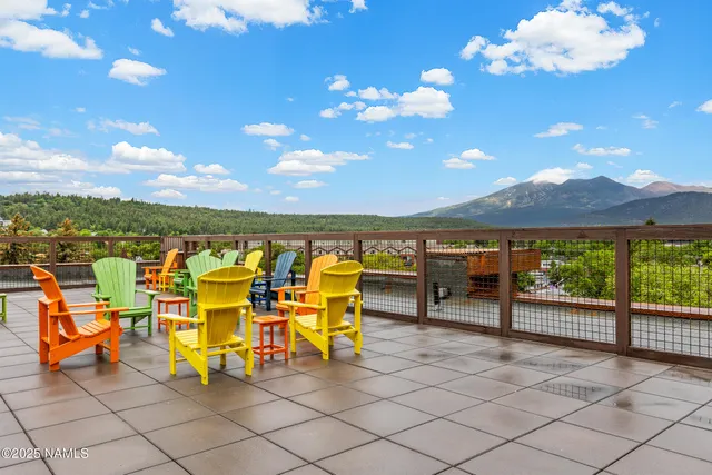 a view of a terrace with furniture and umbrella