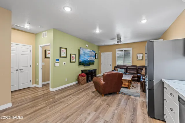 a living room with furniture and a wooden floor