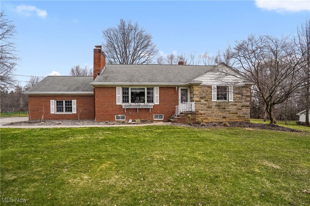 33825 Cannon Road Solon, OH 44139 - Photo 1 of 44 Cape Cod-style house featuring a chimney, brick siding, and a front lawn