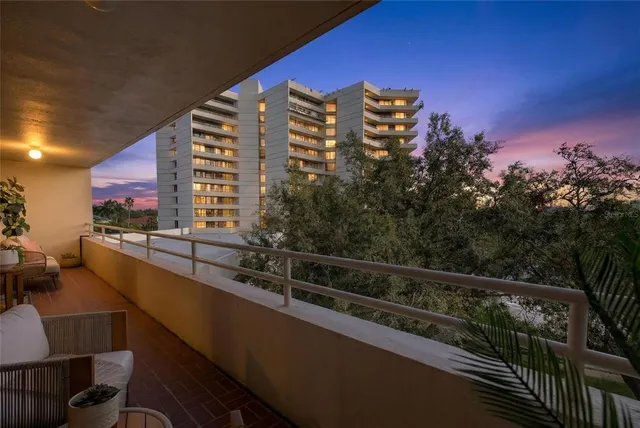 a living room with furniture large windows and a flat screen tv