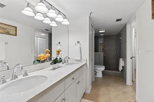 a view of a patio with couches chairs potted plants and palm tree