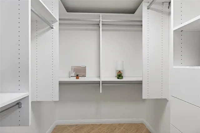 a view of a street with a building and trees in the background