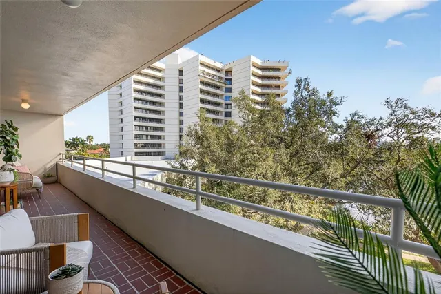 an aerial view of a city with lots of residential buildings ocean and mountain view in back