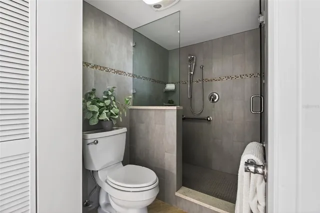 a balcony with outdoor seating and city view