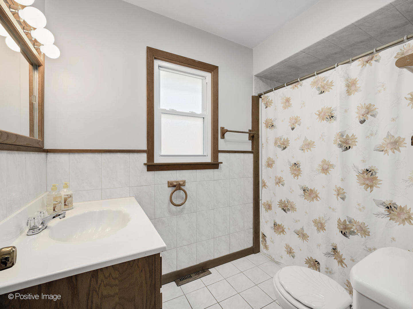 5102 Butterfield Road Hillside, IL 60162 - Photo 12 of 22 a bathroom with a sink toilet and shower