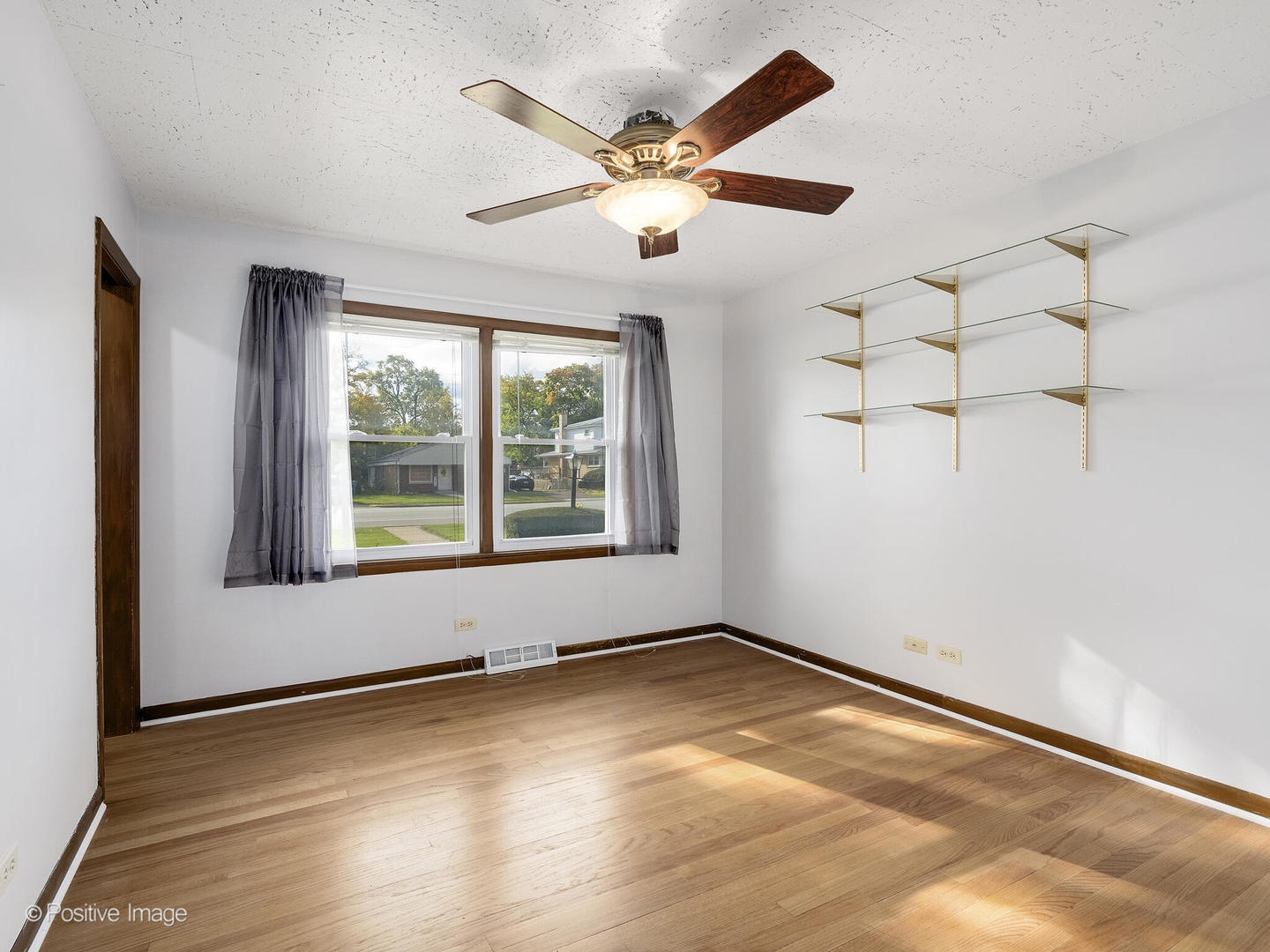 5102 Butterfield Road Hillside, IL 60162 - Photo 13 of 22 an empty room with wooden floor and windows