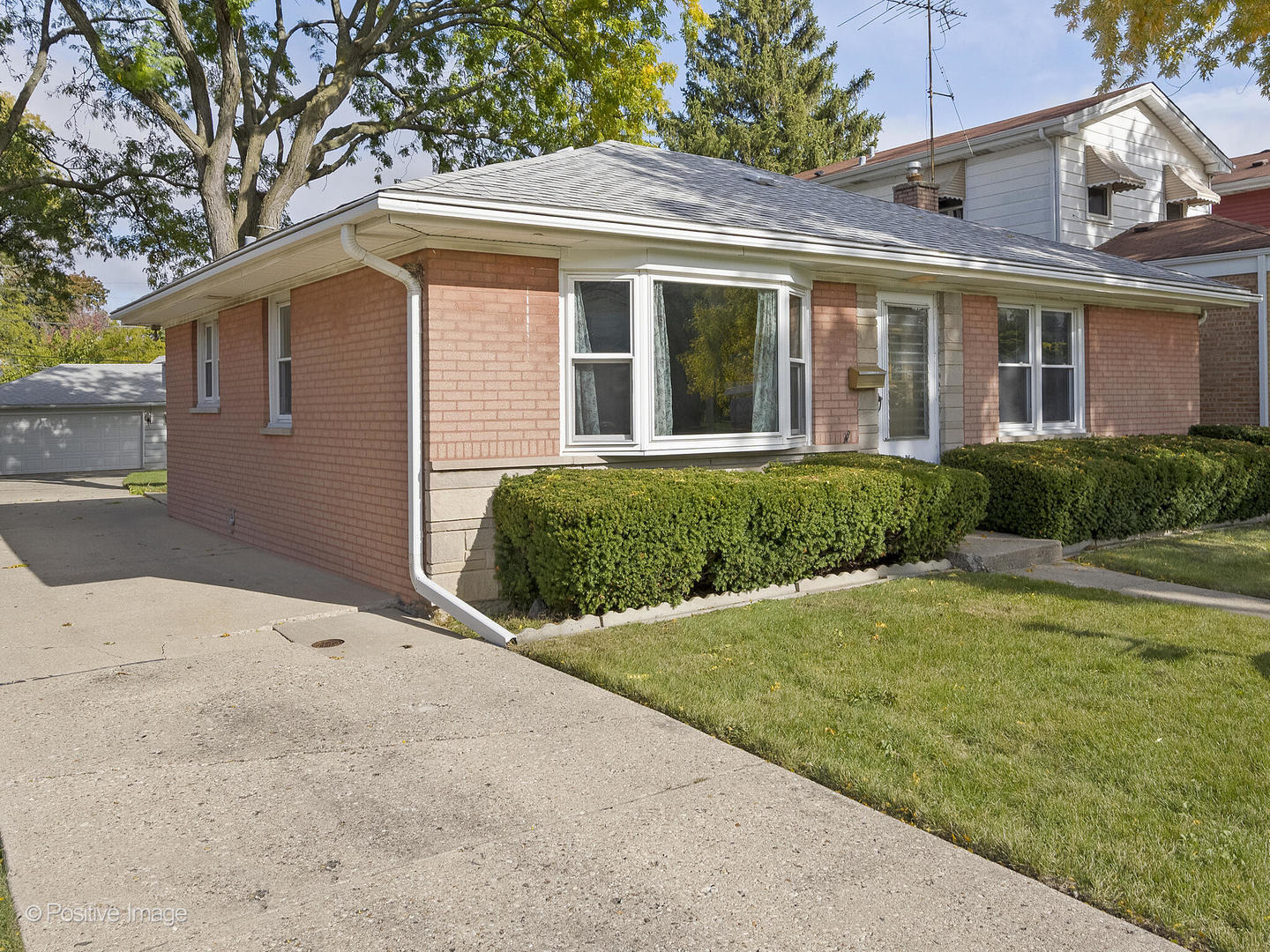 5102 Butterfield Road Hillside, IL 60162 - Photo 2 of 22 a front view of a house with a yard and garage