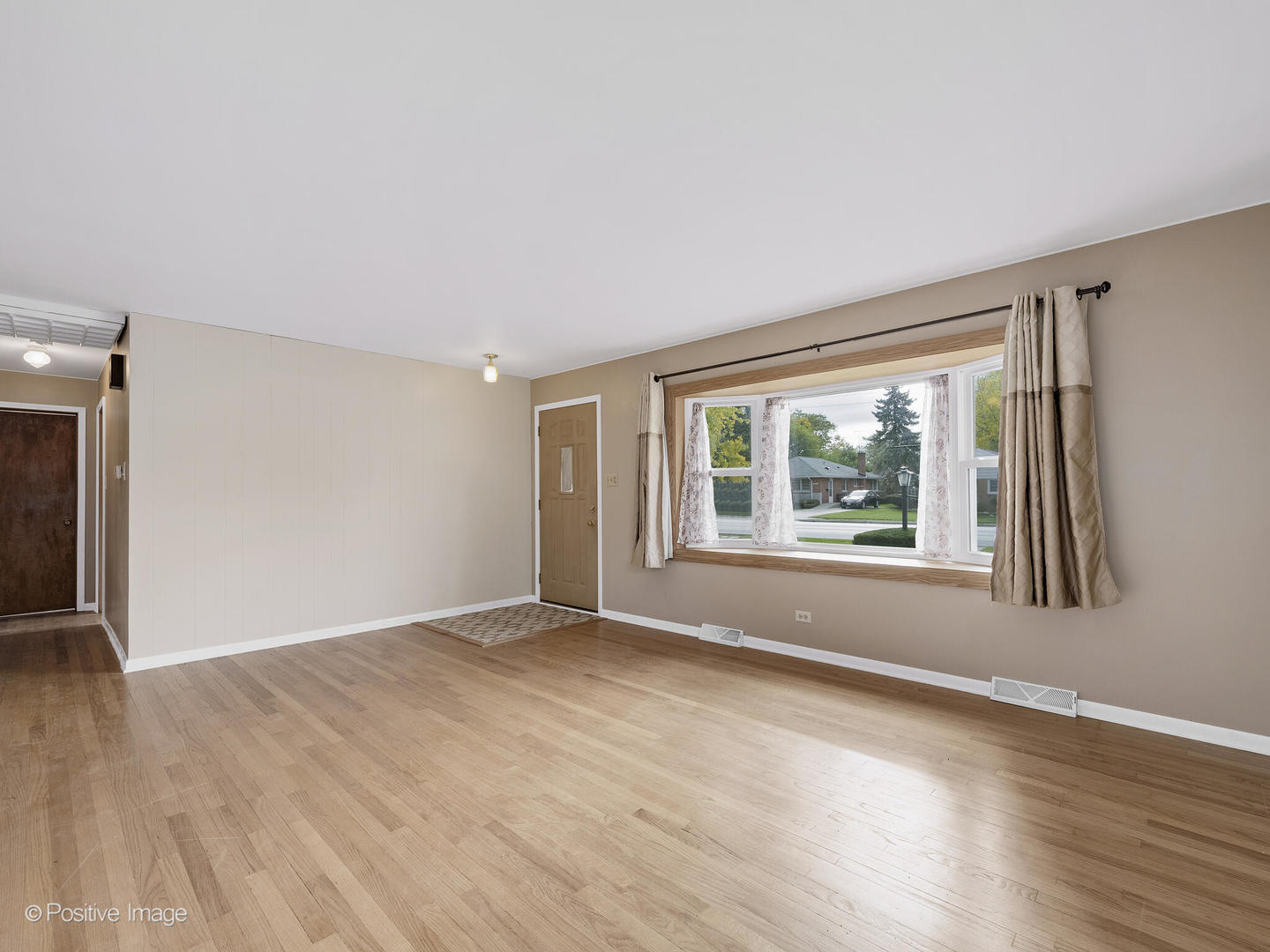 5102 Butterfield Road Hillside, IL 60162 - Photo 4 of 22 a view of an empty room with wooden floor and a window
